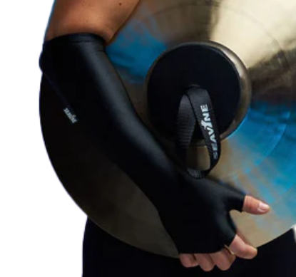 Right arm of a person wearing a long black spandex glove while holding a crash cymbal